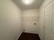 Laundry room with white walls, dark floors, and wire shelving ready for appliances at 110 Slate Ridge Ln, Loganville, GA 30052
