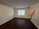 Bright living room with dark laminate floors and a large window at 110 Slate Ridge Ln, Loganville, GA 30052