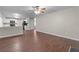 Spacious open concept living room with ceiling fan, kitchen and access to the staircase at 110 Slate Ridge Ln, Loganville, GA 30052