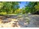 Serene backyard featuring a bench, expansive lawn, and mature trees at 821 Ralph Mcgill Ne Blvd # 3325, Atlanta, GA 30306