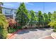 Inviting exterior view with mature trees and colorful landscaping at 821 Ralph Mcgill Ne Blvd # 3325, Atlanta, GA 30306