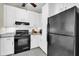 Bright kitchen with white cabinets, granite countertops, and black appliances at 821 Ralph Mcgill Ne Blvd # 3325, Atlanta, GA 30306
