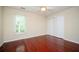 Bedroom with wood floors, window and closet with folding doors at 2980 Milford Sw Trl, Marietta, GA 30008
