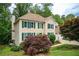 Charming two-story home with a tan exterior, green shutters, well-manicured lawn, and an attached two-car garage at 2980 Milford Sw Trl, Marietta, GA 30008