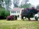 Well-maintained two-story home with green shutters, a beautiful lawn and mature trees at 2980 Milford Sw Trl, Marietta, GA 30008