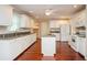 Well-equipped kitchen with white cabinetry, granite countertops, and an island at 2980 Milford Sw Trl, Marietta, GA 30008