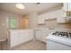 Functional kitchen with breakfast bar, white cabinets and appliances at 2980 Milford Sw Trl, Marietta, GA 30008
