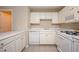 Bright kitchen with white cabinets, appliances, and tile flooring at 2980 Milford Sw Trl, Marietta, GA 30008