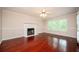 Inviting living room features hardwood floors, a fireplace, and large windows at 2980 Milford Sw Trl, Marietta, GA 30008