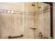 Shower stall with patterned tile, shower head, and glass door at 2980 Milford Sw Trl, Marietta, GA 30008