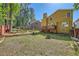 Spacious backyard view featuring lush lawn, mature trees, and a patio at 3812 Maclaren Dr, Clarkston, GA 30021