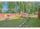 View of grassy backyard featuring mature trees and a wood fence at 3812 Maclaren Dr, Clarkston, GA 30021