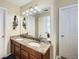 Bathroom featuring a double sink vanity with granite countertop, large mirror, and white doors at 3812 Maclaren Dr, Clarkston, GA 30021