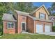 Inviting brick home with attached two-car garage, front yard and classic architectural details at 3812 Maclaren Dr, Clarkston, GA 30021