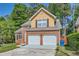 Beautiful two-story home with a brick facade, attached garage, and mature trees at 3812 Maclaren Dr, Clarkston, GA 30021