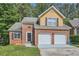 Charming brick home featuring a two-car garage and manicured lawn, offering great curb appeal at 3812 Maclaren Dr, Clarkston, GA 30021