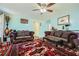 Cozy living room featuring decorative rugs, ornate sofas, and ceiling fan for a relaxing ambiance at 3812 Maclaren Dr, Clarkston, GA 30021