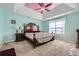 Spacious main bedroom with tray ceiling, fan, side tables, and large window with natural light at 3812 Maclaren Dr, Clarkston, GA 30021