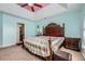 Main bedroom with tray ceiling and fan, featuring an en suite bathroom and sitting area at 3812 Maclaren Dr, Clarkston, GA 30021