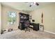 Home office with built-in shelving, computer setup, and natural light from a large window at 3812 Maclaren Dr, Clarkston, GA 30021