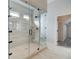 Glass enclosed shower with tile surround and bench in the modern bathroom at 3890 Ivy Cottage Dr, Snellville, GA 30039