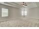Spacious bedroom with neutral carpet, a ceiling fan, and lots of natural light from the windows at 3890 Ivy Cottage Dr, Snellville, GA 30039