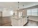 Open concept kitchen with stainless appliances, granite countertops, and a view of the living room at 3890 Ivy Cottage Dr, Snellville, GA 30039