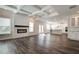 Open concept living area with fireplace, coffered ceilings, kitchen and hardwood floors at 3890 Ivy Cottage Dr, Snellville, GA 30039