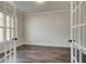 Home office with elegant French doors and hardwood floors provides a quiet workspace at 3890 Ivy Cottage Dr, Snellville, GA 30039