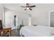 Bright bedroom with hardwood floors, neutral walls, ceiling fan, and access to bathroom and walk-in closet at 665 Ferris St, Atlanta, GA 30310