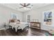 Well-lit bedroom featuring hardwood floors, neutral walls, ceiling fan, windows, and a metal bed frame at 665 Ferris St, Atlanta, GA 30310