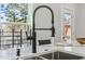 Close up view of a modern kitchen sink with a high-arc faucet and marble countertops at 665 Ferris St, Atlanta, GA 30310