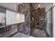 Modern shower with glass door and beautiful stone paneling provides a luxurious and private bathing experience at 665 Ferris St, Atlanta, GA 30310