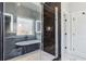 Sleek shower with glass doors and dark marble, seamlessly connects to a luxurious soaking tub at 665 Ferris St, Atlanta, GA 30310