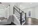 Modern staircase with metal railings and hardwood floors leading to the upper level at 665 Ferris St, Atlanta, GA 30310