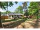 A backyard with a patio and outdoor furniture, enclosed by a wooden fence and mature trees at 874 Fox Valley Dr, Stone Mountain, GA 30088