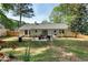 A backyard with a patio and outdoor furniture, enclosed by a wooden fence at 874 Fox Valley Dr, Stone Mountain, GA 30088