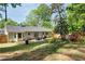 Backyard with patio, outdoor furniture, wooden fence, mature trees, and a manicured lawn at 874 Fox Valley Dr, Stone Mountain, GA 30088