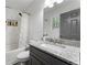 Bathroom featuring a granite countertop, grey vanity, shower with tile surround, and a window at 874 Fox Valley Dr, Stone Mountain, GA 30088