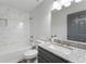 Bathroom featuring a granite countertop, grey vanity, shower with tile surround, and a window at 874 Fox Valley Dr, Stone Mountain, GA 30088