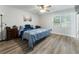 Bedroom featuring a ceiling fan, a bed with blue bedding, and natural light from the window at 874 Fox Valley Dr, Stone Mountain, GA 30088