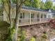 Charming front porch with wood floors, comfortable seating, and scenic views of the landscaped garden at 874 Fox Valley Dr, Stone Mountain, GA 30088