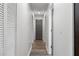 Hallway with doors, white walls, wood-look flooring, and a closet on the left at 874 Fox Valley Dr, Stone Mountain, GA 30088