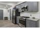 Bright kitchen with stainless appliances, gray cabinets and granite countertops at 874 Fox Valley Dr, Stone Mountain, GA 30088