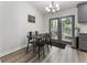 Eat-in kitchen with modern chandelier and double doors leading to the backyard at 874 Fox Valley Dr, Stone Mountain, GA 30088