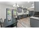 Eat-in kitchen with gray cabinets, stainless appliances, granite countertops and double doors leading to a patio at 874 Fox Valley Dr, Stone Mountain, GA 30088