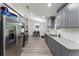 Open concept kitchen with stainless appliances, gray cabinets and granite countertops at 874 Fox Valley Dr, Stone Mountain, GA 30088