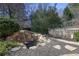Backyard featuring rock waterfall with pond, wood fence and mature landscaping at 10462 Bent Tree Vw, Duluth, GA 30097