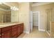 Bathroom with double vanity, wood cabinets, large mirror, and a tile-surround shower at 10462 Bent Tree Vw, Duluth, GA 30097
