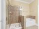 Bathroom featuring a glass-enclosed shower and separate tub with tile surround, all in neutral tones at 10462 Bent Tree Vw, Duluth, GA 30097